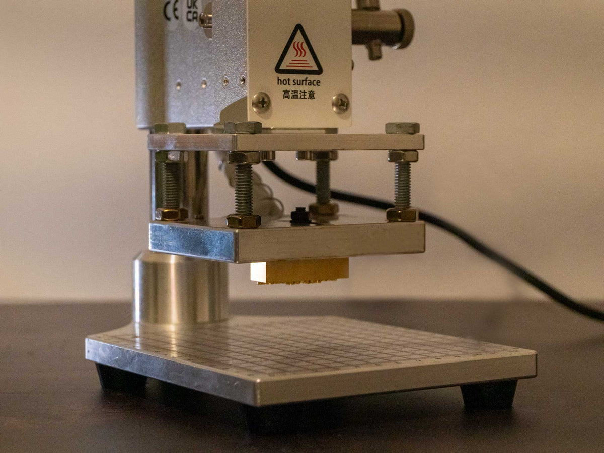 Hot stamping machine with leather stamp mounted