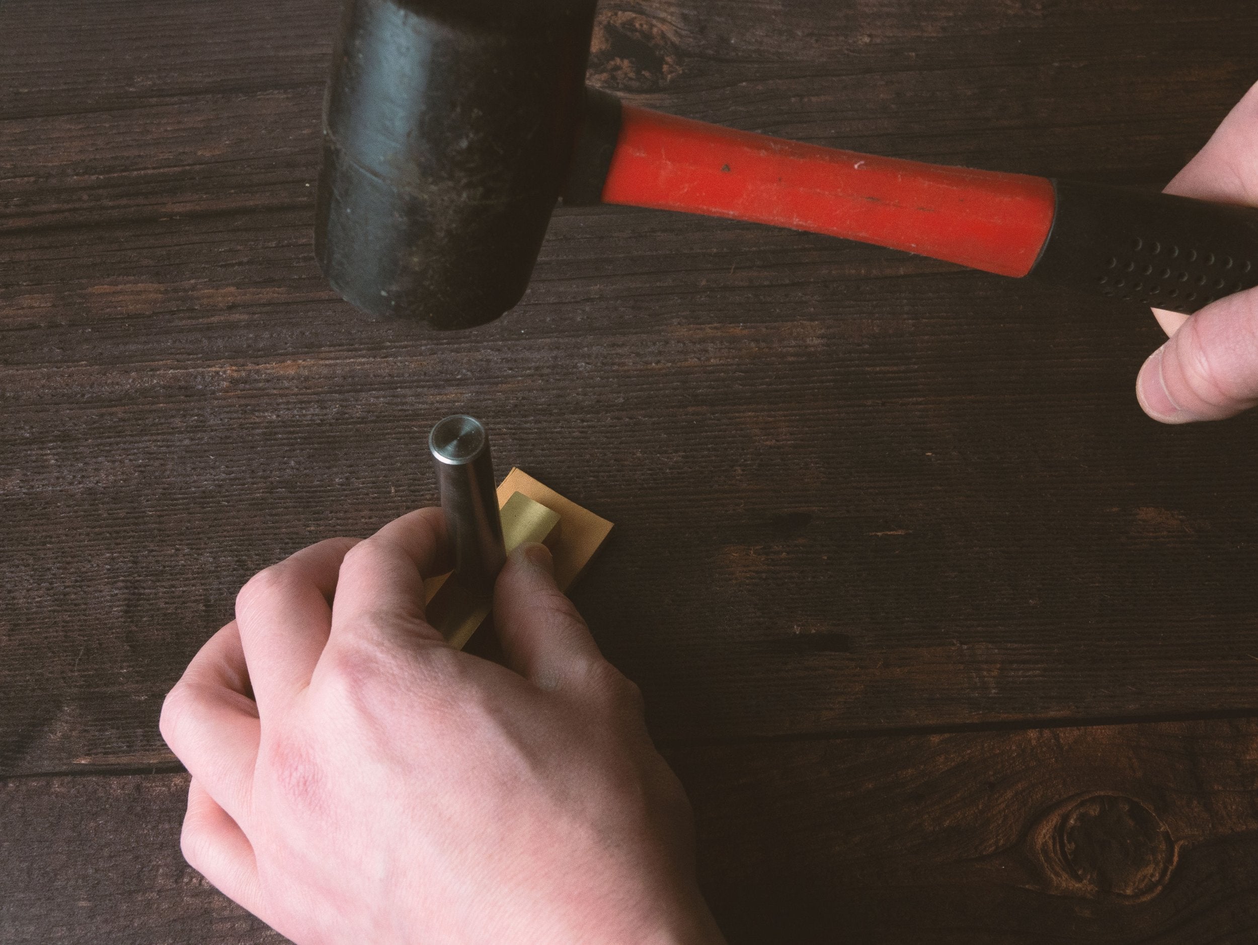 Hammering Embossing Stamp into Leather - Outpost Workshop